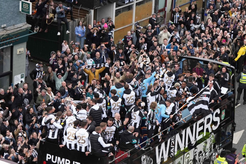 Newcastle United players celebrate their Carabao Cup victory in a parade.