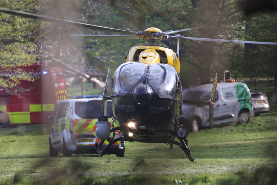 Helicopter and emergency vehicles at a search and rescue operation.