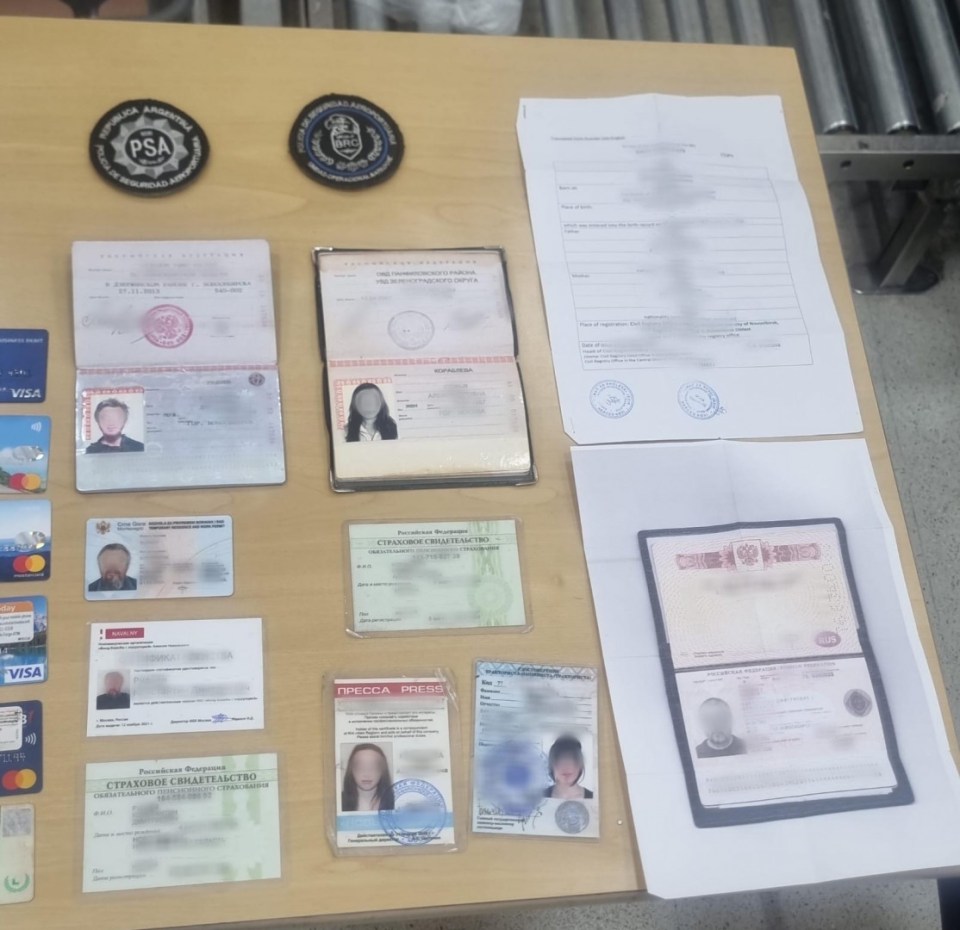Seized passports and identification documents from a human trafficking investigation.