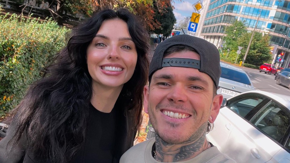 Photo of a man and woman smiling for a selfie.