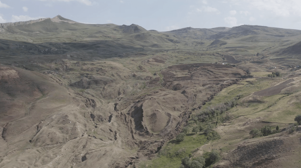 Aerial view of a mountainous landscape with erosion.