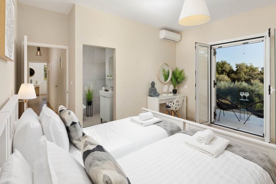Twin bedroom with balcony view.