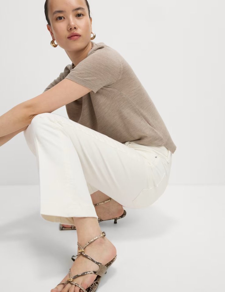 Woman modeling high-waisted slim flare cropped jeans.
