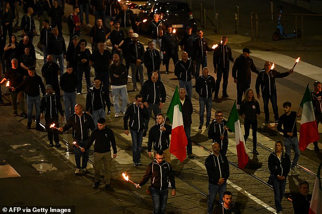Neo-fascist and members of extreme far-right groups hold torches as they gather to mark the 50th anniversary of the death of Sergio Ramelli