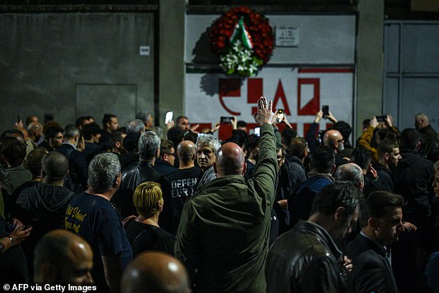 A man performs the fascist salute towards Ramelli's mural in Milan before Ramelli's name was chanted three times