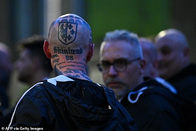 A man with a tattoo reading 'Skinhead 88' attended the neo-fascist rally