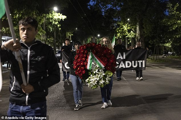 A wreath of red flowers was also carried at the beginning of the procession