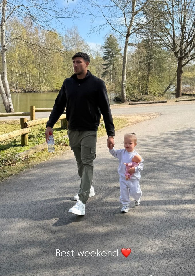 Man and toddler holding hands while walking.