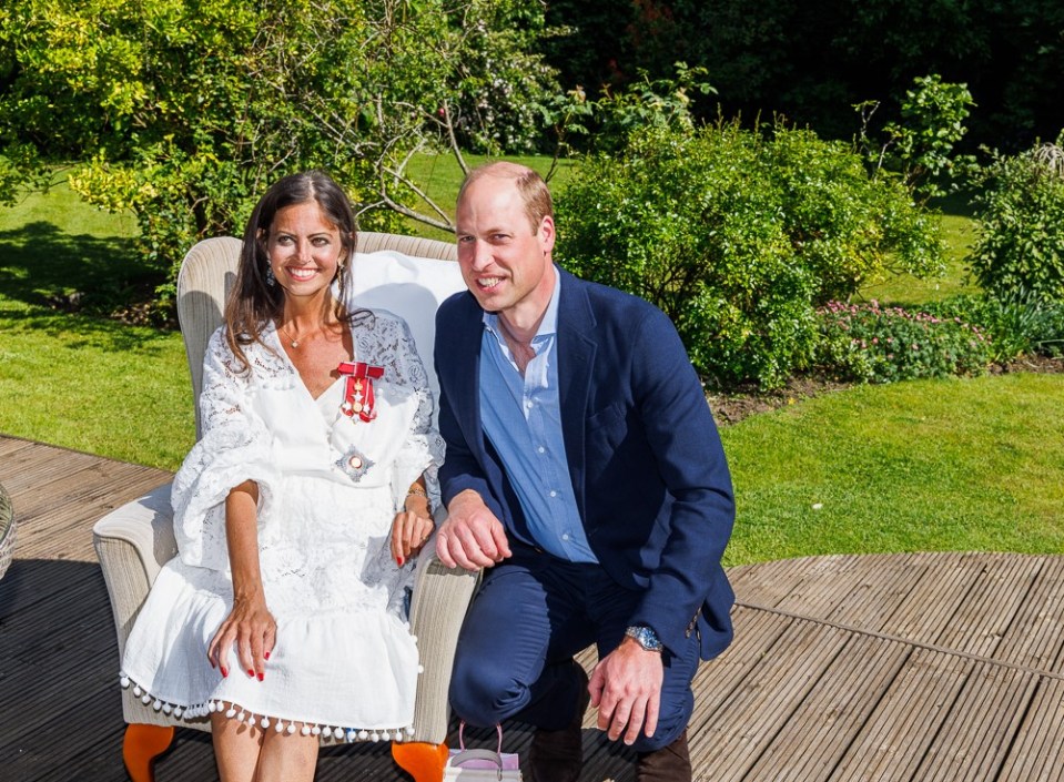 Prince William presenting Deborah James with her Damehood.