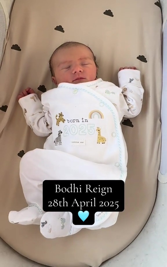 Newborn baby Bodhi Reign sleeping in a bassinet.