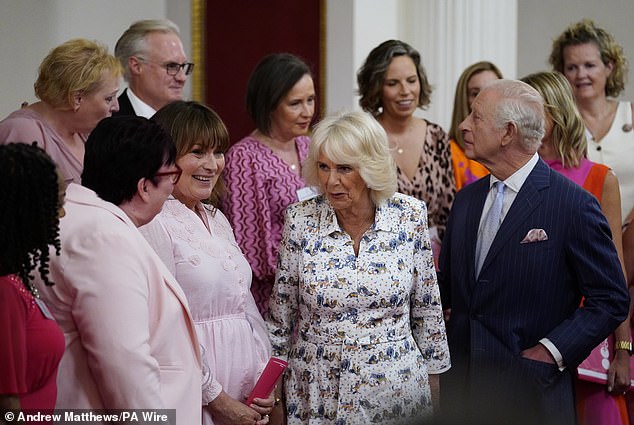King Charles III and Queen Camilla speak with presenter Lorraine Kelly (second left) and the members of the Change + Check Choir