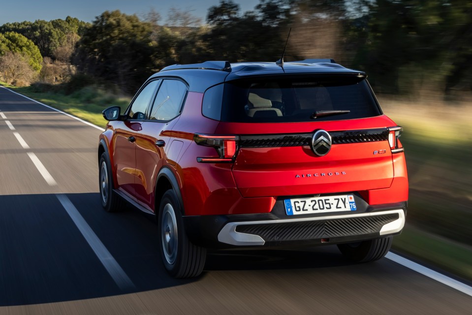Red Citreon eC3 Aircross driving on a road.