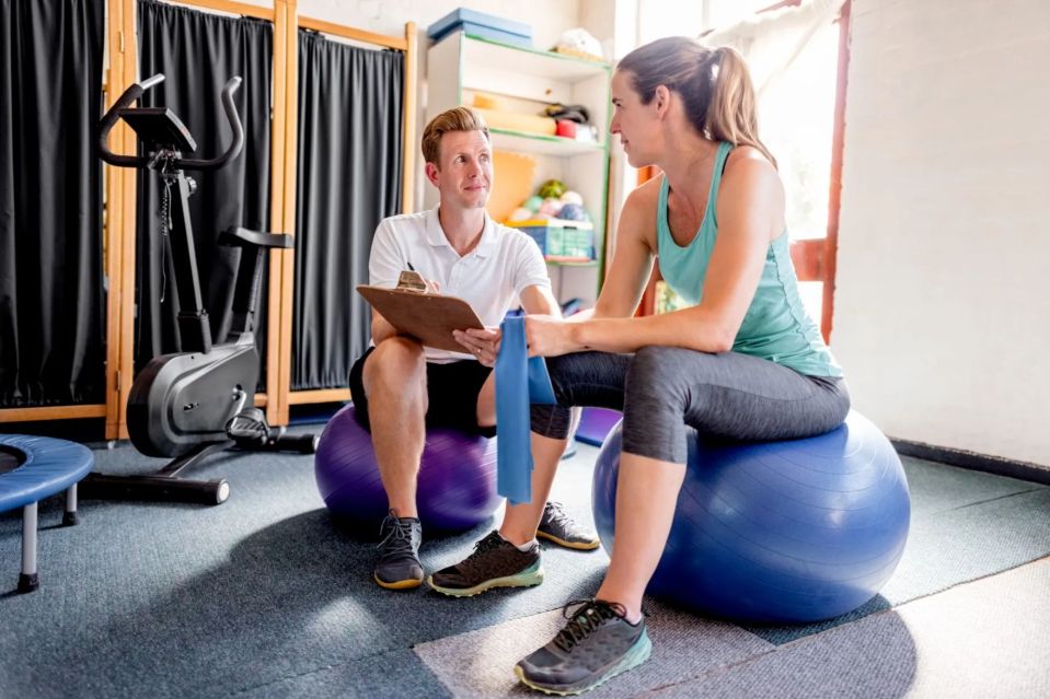 Physical therapist consulting with patient.