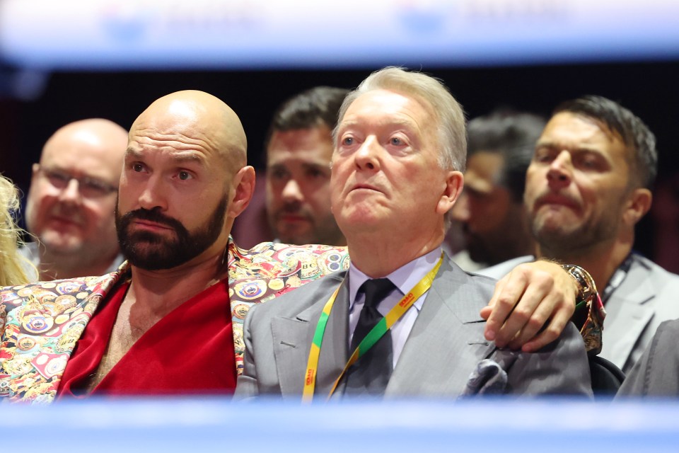 Tyson Fury embracing Frank Warren at a boxing match.