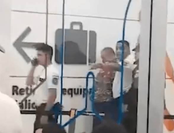 Security personnel detaining a person at an airport.