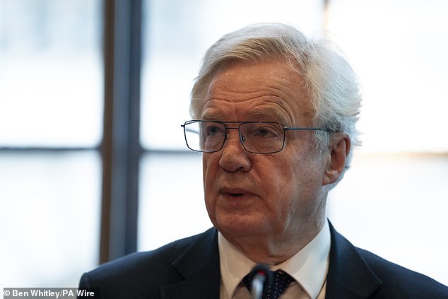 A 'professional thief' swiped a bag from senior Conservative MP Sir David Davis (pictured) during a £15,000 crime spree, a court has been told