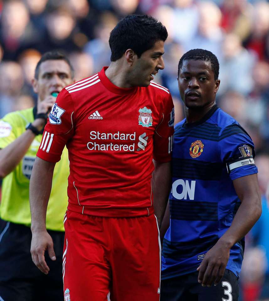 Luis Suárez and Patrice Evra during a soccer match.