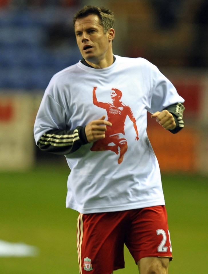 Jamie Carragher warming up in a t-shirt supporting Luis Suarez before a football match.