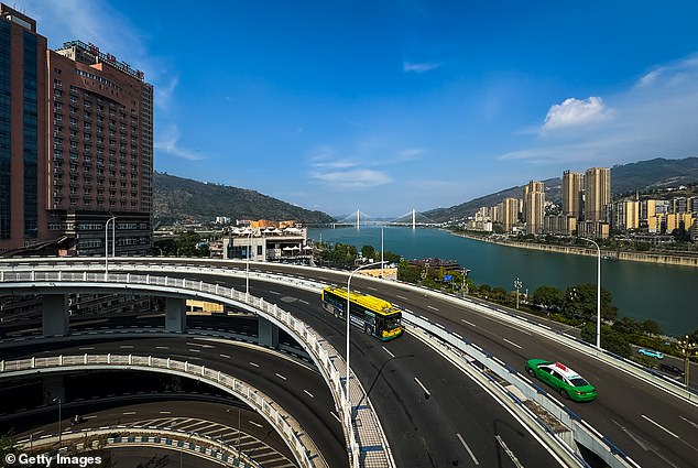 view of the U-shaped overpass near the confluence of the Wujiang River and the Yangtze River, with the Shibangou Yangtze River Bridge visible in the distance, on October 15, 2024 in Chongqing, China