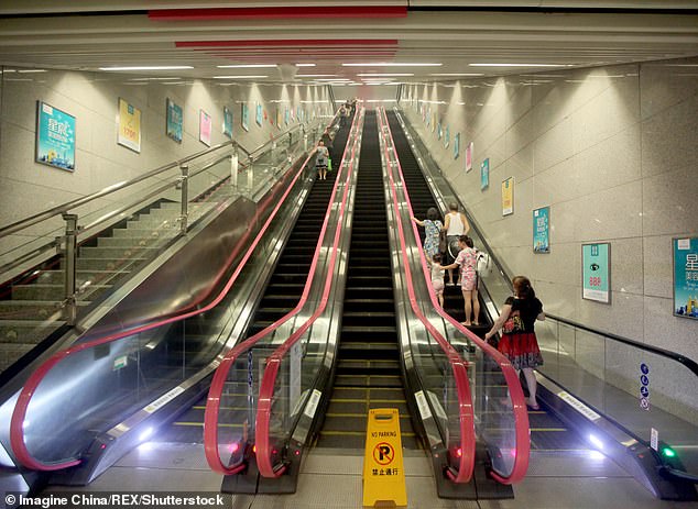 Passengers stand on an escalator at Hongtudi Subway Station which is 60 meters underground, of Line 6, in Chongqing Deepest subway station, Hongtudi, which is 60 meters underground, of Line 6, in Chongqing, China