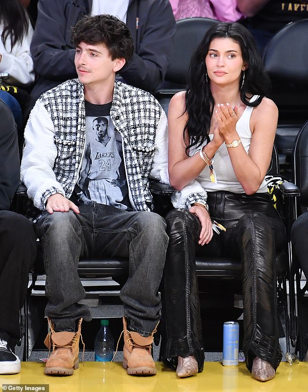 For the game, Jenner rocked black leather trousers styled with a low-cut white tank top and designer boots