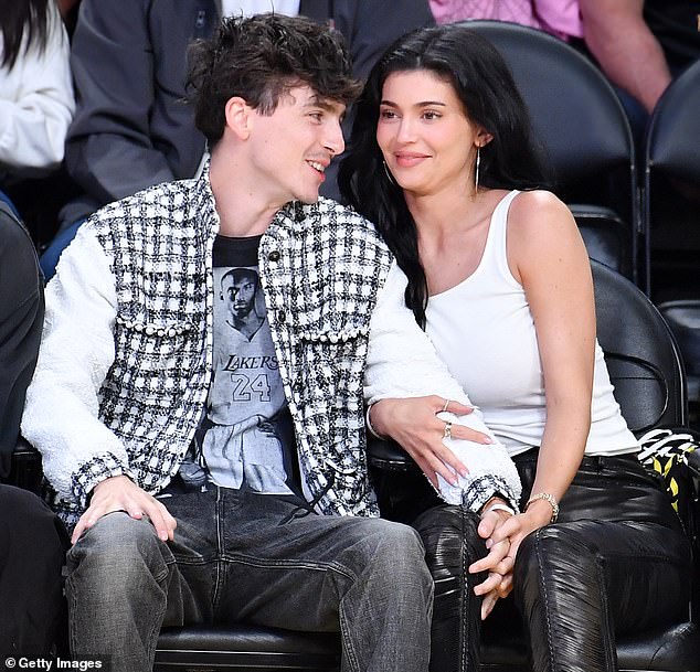 Jenner kept a tight grip on Chalamet's left hand and arm as they watched the rival basketball teams play