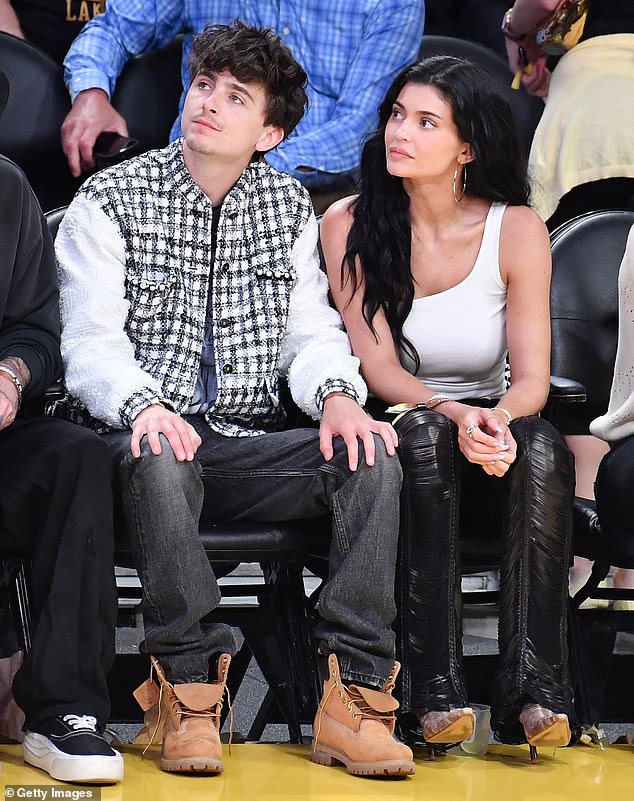 Chalamet rocked Timberland boots, faded jeans and a spliced plaid jacket over a Kobe Bryant T-shirt