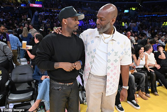 He wrapped an arm around pal and sports agent Rich Paul - who is married to superstar Adele