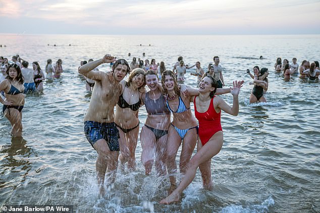 Students from the University of St Andrews take part in the traditional May Day Dip today