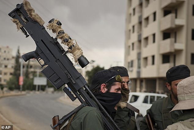 Members of Syria's security forces deploy during an operation in the edge of the town of Sahnaya, south of Damascus, Wednesday April 30, 2025