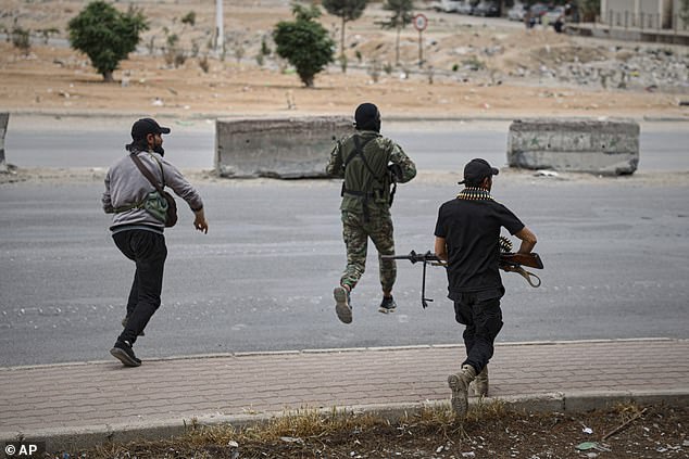 Members of Syria's security forces deploy as a sniper fires during an operation on the outskirts of the town of Sharaya, south of Damascus, Wednesday, April 30, 2025