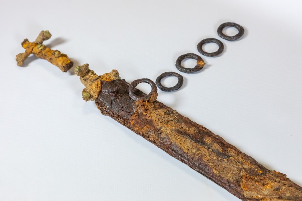 Rusty metal sword and rings.