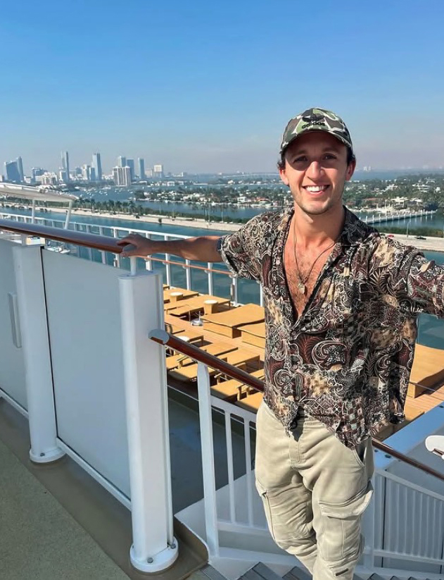 Man on cruise ship overlooking Miami skyline.