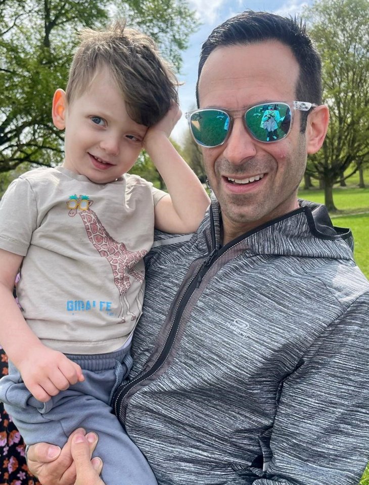 A father holding his young son.