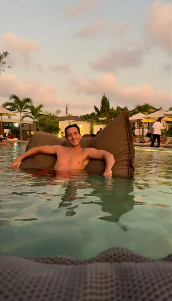 Man relaxing in a pool on a beanbag chair.