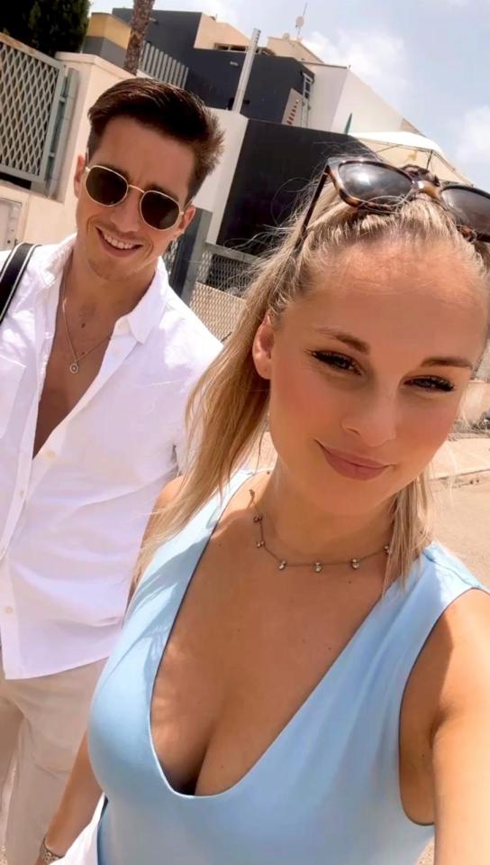 Couple posing outdoors.