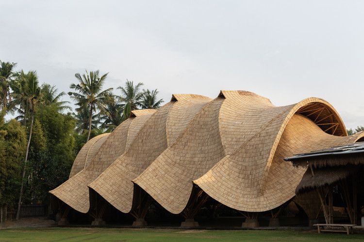 Bamboo structure with a wavy thatched roof.
