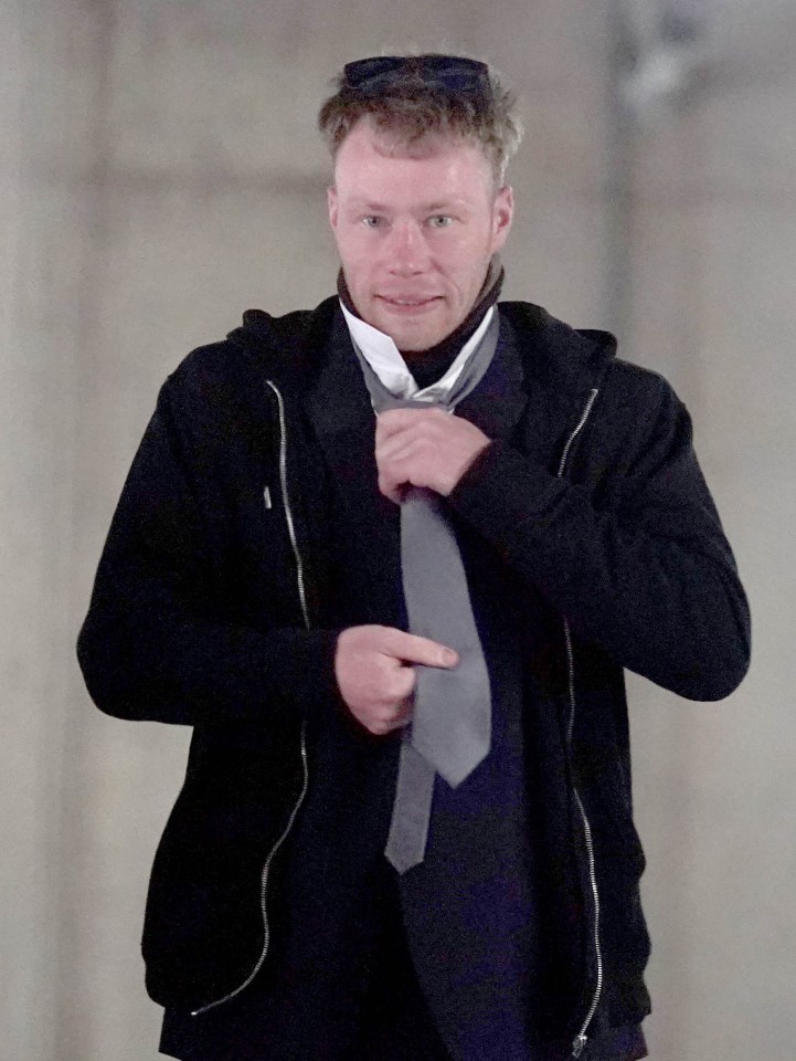 Adam Carruthers adjusting his tie at Newcastle Crown Court.