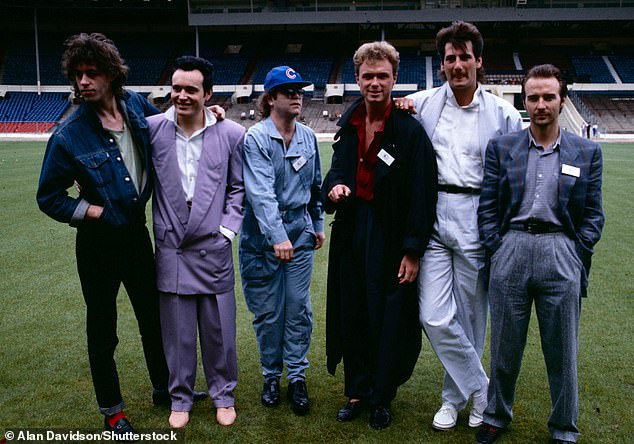 L-R: Bob Geldof, Adam Ant, Sir Elton John, Gary Kemp, Tony Hadley and Midge Ure attend a Wembley Stadium press conference ahead of Live Aid in 1985