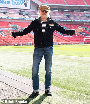 Geldof wore a Breton shirt and jeans for his visit to the stadium...