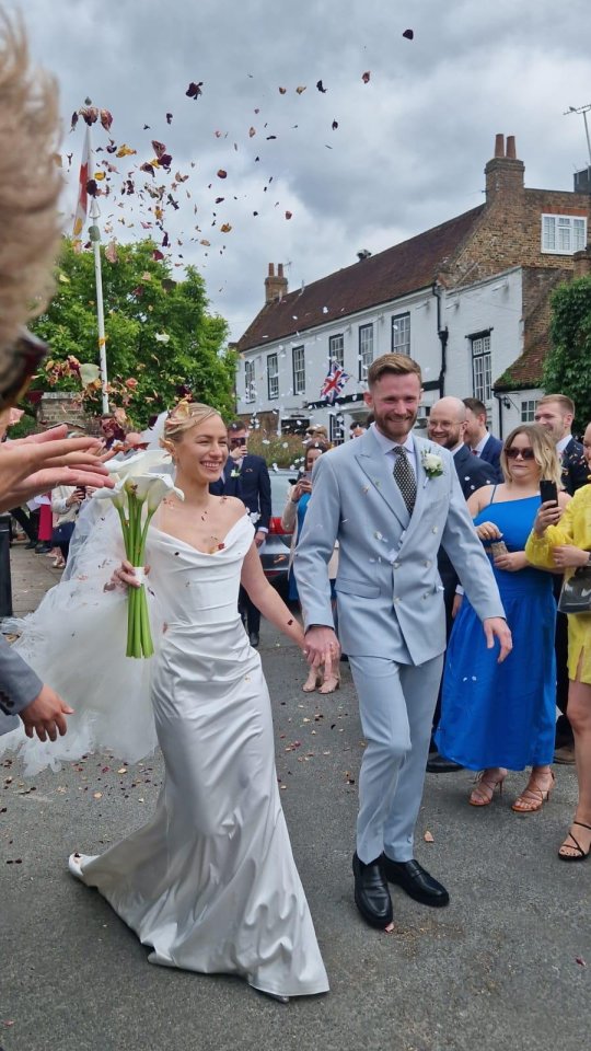 Bride and groom leaving their wedding ceremony, showered with confetti.