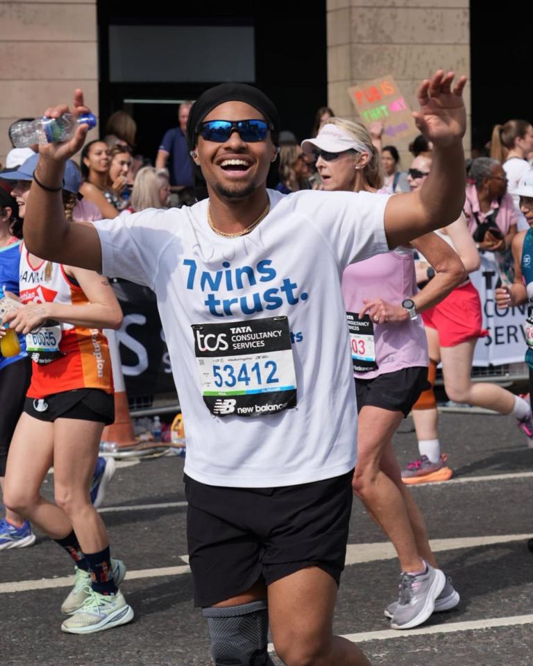 Man in Twins Trust running shirt finishes marathon.