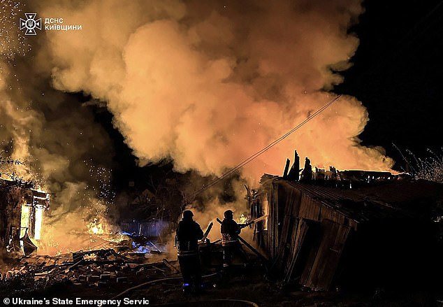 The dictator's life of luxury stands in sharp contrast to the suffering endured by his soldiers on the brutal frontlines of Ukraine. Pictured: Ukrainian firegighters extinguishing a fire at the site of a Russian drone attack in Kyiv