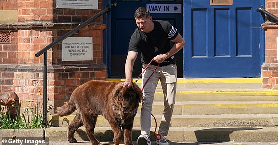 HULL, ENGLAND - MAY 01: Luke Campbell, Reform UK candidate for the Hull and East Yorkshire Combined County Authority Mayoral election walks with his dog, Lexi, after voting as local elections are held in England on May 01, 2025 in Hull, England. Voters across England will elect four regional mayors and 1,750 councillors on Thursday, 1 May 2025. (Photo by Ian Forsyth/Getty Images)