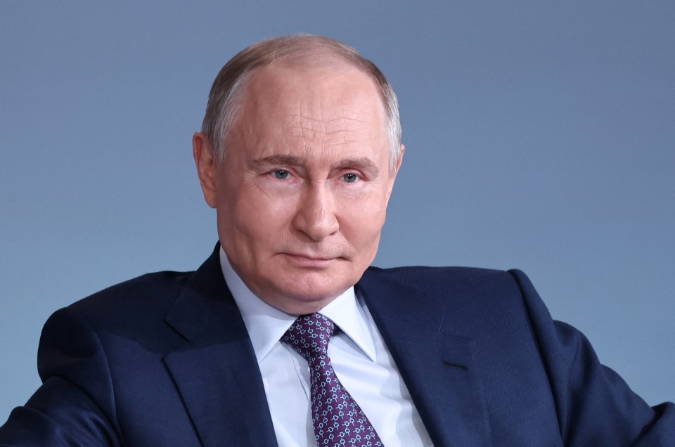 Vladimir Putin in a dark blue suit.