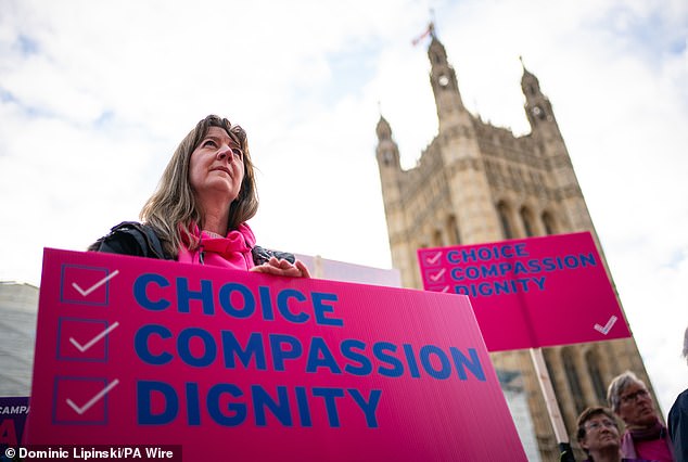 A protester outside the Houses of Parliament in London calling for reform as peers debate the new assisted dying legislation