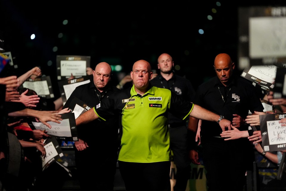 Michael van Gerwen walking through a crowd of fans.