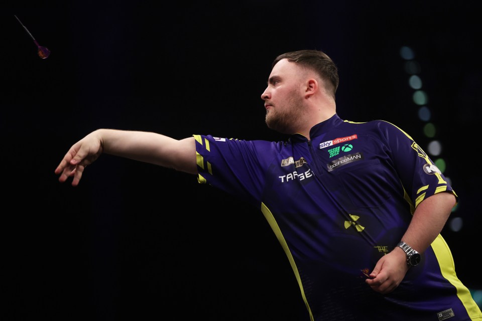 Luke Littler throwing a dart during a match.