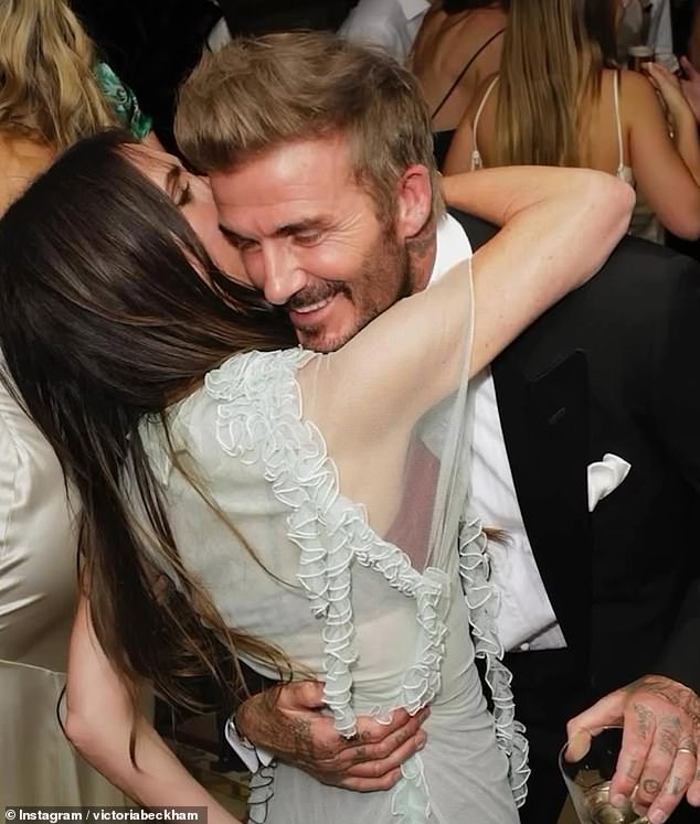 David donned a black tuxedo and white shirt as he embraced his wife who was wearing a sheer dress