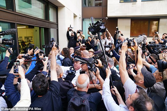 Police had to battle to hold back the crowd of photographers as Brand arrived at Westminster Magistrates Court